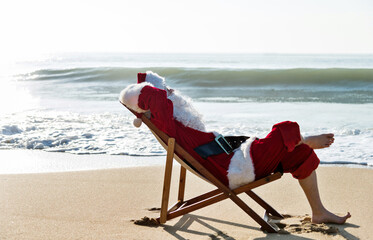 Christmas santa claus lying on a beach chair.