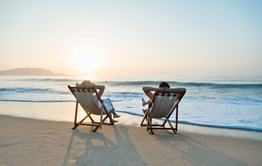 Couple sunbathing on a beach chair.