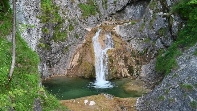 A waterfall with a beautiful pool in the mountains