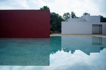 Luis Barragan's Cuadra San Cristobal pink wall, endemic vegetation and sandy ground in the...