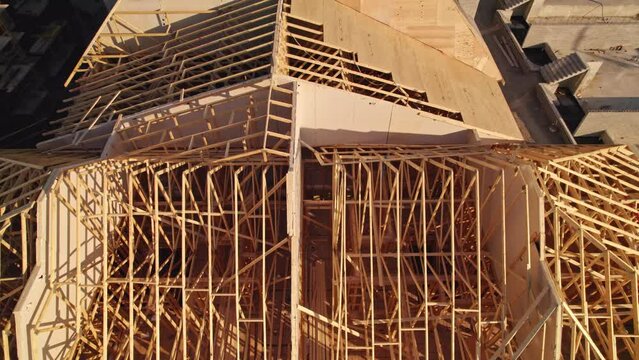 House construction and its wooden roof. Wooden housing. Timber frame house in North American downtown real estate.