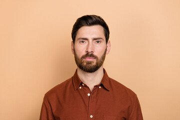 Portrait of calm focused concentrated person look camera isolated on pastel beige color background