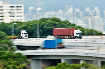 Container trucks motion blur on highway overpass