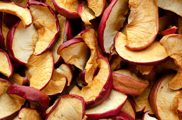 Dried apple slices as a background, top view. Close-up of sliced dry apples, background, texture, top view. Collection of dry sliced apples, background, texture, top view.