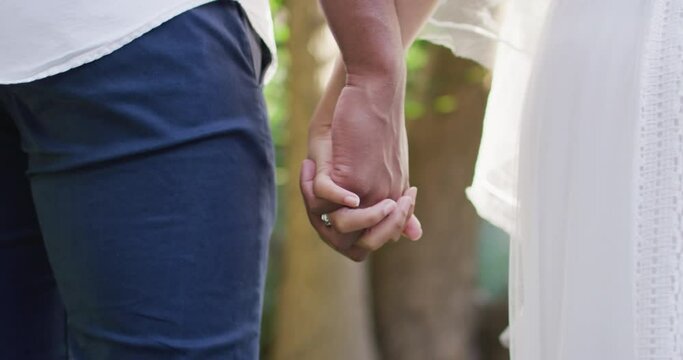 Close up of married african american couple holding hands