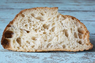 Fresh homemade sourdough bread with whole grain flour on a gray-blue background. Healthy food.