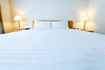 White bed sheet and pillows in hotel room