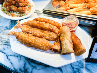 Vietnamese fried rolls and prawn tempura served on the street food market