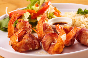 Fried shrimp with bacon, sweet sauce, salad and rice, food, gastronomy