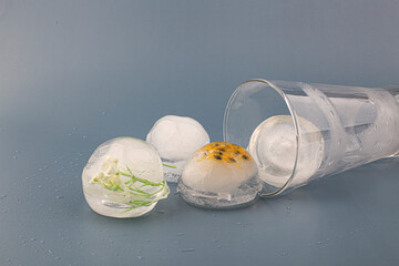 glass of water with ice ball isolated