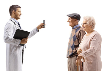 Young doctor showing a mobile phone to elderly patients