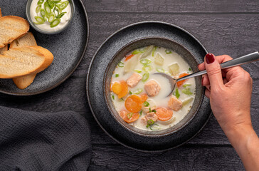 Food photography of salmon soup, potato, carrot, cream, onion, toast