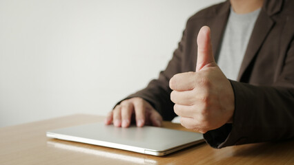 Business man showing thumb up sign gesture to congratulate your success.