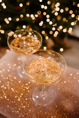 New Year's Eve 2022-2023 Celebration Background with Champagne. Champagne glasses on glitter background. Three champagne glasses ready to bring in the New Year.