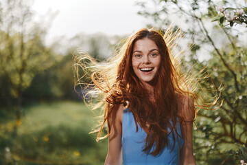 Woman portrait smile happiness catch looks into the camera with a smile with teeth spring flying...