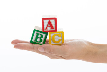 The hand holding ABC blocks