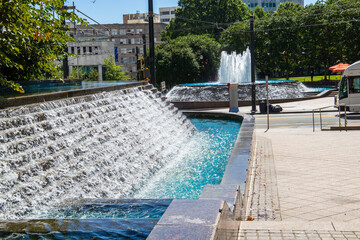 a gorgeous autumn landscape at Woodruff Park with a staircase water fountain and a circular...