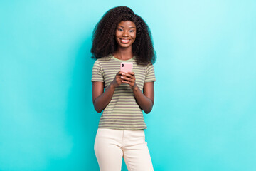 Photo of cute adorable lady wear striped t-shirt communicating modern device isolated turquoise color background