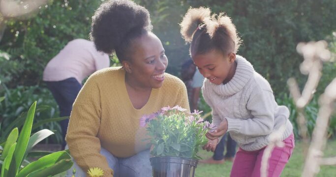 African american family working in garden on sunny day