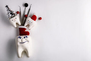 Tooth figurines and dental tool for christmas and new year 2023, top view. holiday medical concept