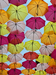 colorful umbrellas against a blue sky background