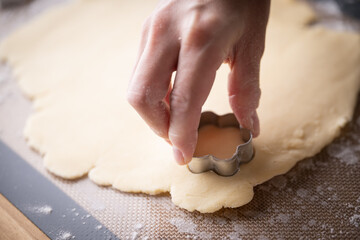 cutting out cookie dough with hands
