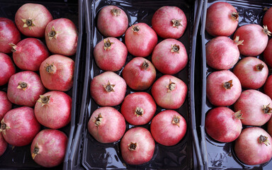 fresh ripe pomegranates in a box