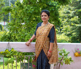 Pretty Indian young lady or woman in  traditional clothes lehanga or saree for festival. Smiling...