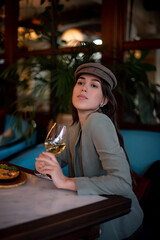 beautiful girl in a cafe drinking wine in ittalian restaurant