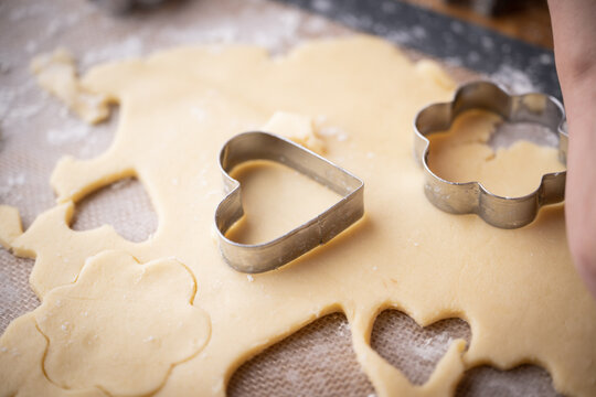 cutting out cookie dough with hands