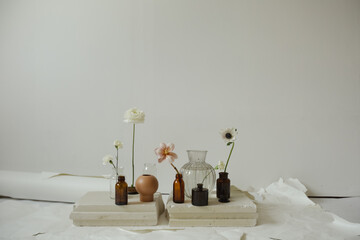 beautiful floral still life in the form of vases and bottles of flowers on a white background