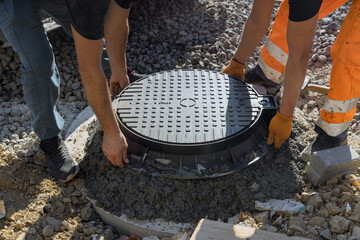 A cast iron sewer installed in concrete well, preparation for installation of water sewer well...