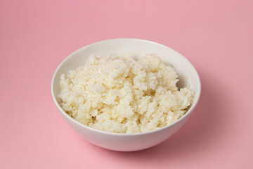 A plate of boiled rice on a pink background. traditional asian food