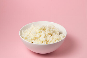 A plate of boiled rice on a pink background. traditional asian food