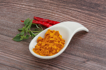 Yellow vibrant curcuma powder in the bowl