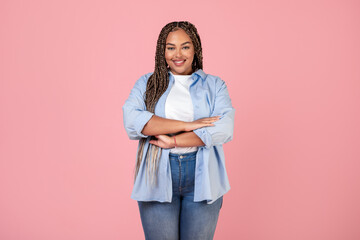 Black Woman Posing Wearing Plus Size Clothes On Pink Background