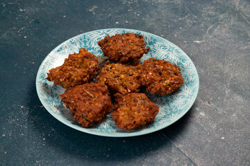 Indian spicy vegetable pakora or pakoda served in dish isolated on table top view