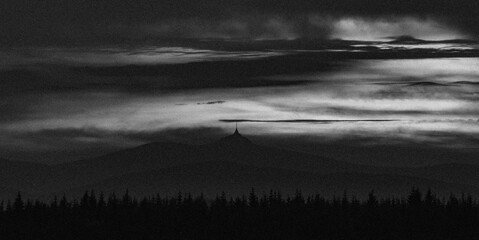 Black and white cloudy sunset near Jested hill over Liberec town in evening