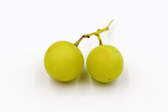 A pair of seedless grapes on white background