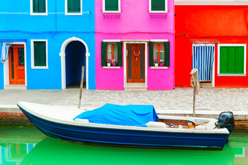 Fototapeta na wymiar Colorful houses on the canal with boat in Burano island, Venice, Italy.