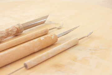 Pottery tools set on a ceramics studio background, in artisan craftsman classes workshop