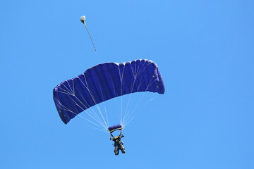 Skydiver flying wing in a blue sky	