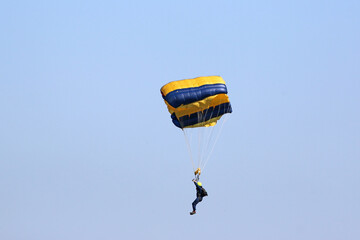 Skydiver flying wing in a blue sky	