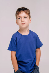 Emotional portrait of boy wearing blue t-shirt.