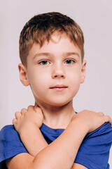 Emotional portrait of boy wearing blue t-shirt.