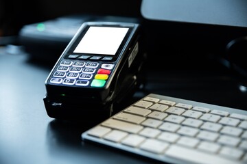 Payment card terminal on the desk with an empty space for a message on the display.