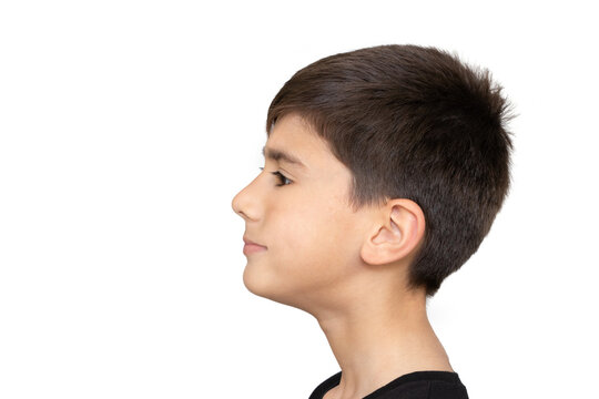 Profile of pretty nice little boy with stylish in T-shirt looking to side with serious attentive face, calm pensive expression. indoor studio shot isolated on white background, copy space