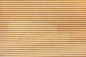 Vintage orange color empty metal roller shutter door background texture. Copy space