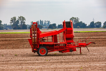 A red onion harvester in a field