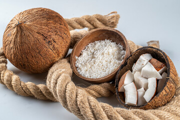 Whole,cut and grated coconut seen on a thick rope.Fresh whole half coconut and sliced and grated,tropical fruit.